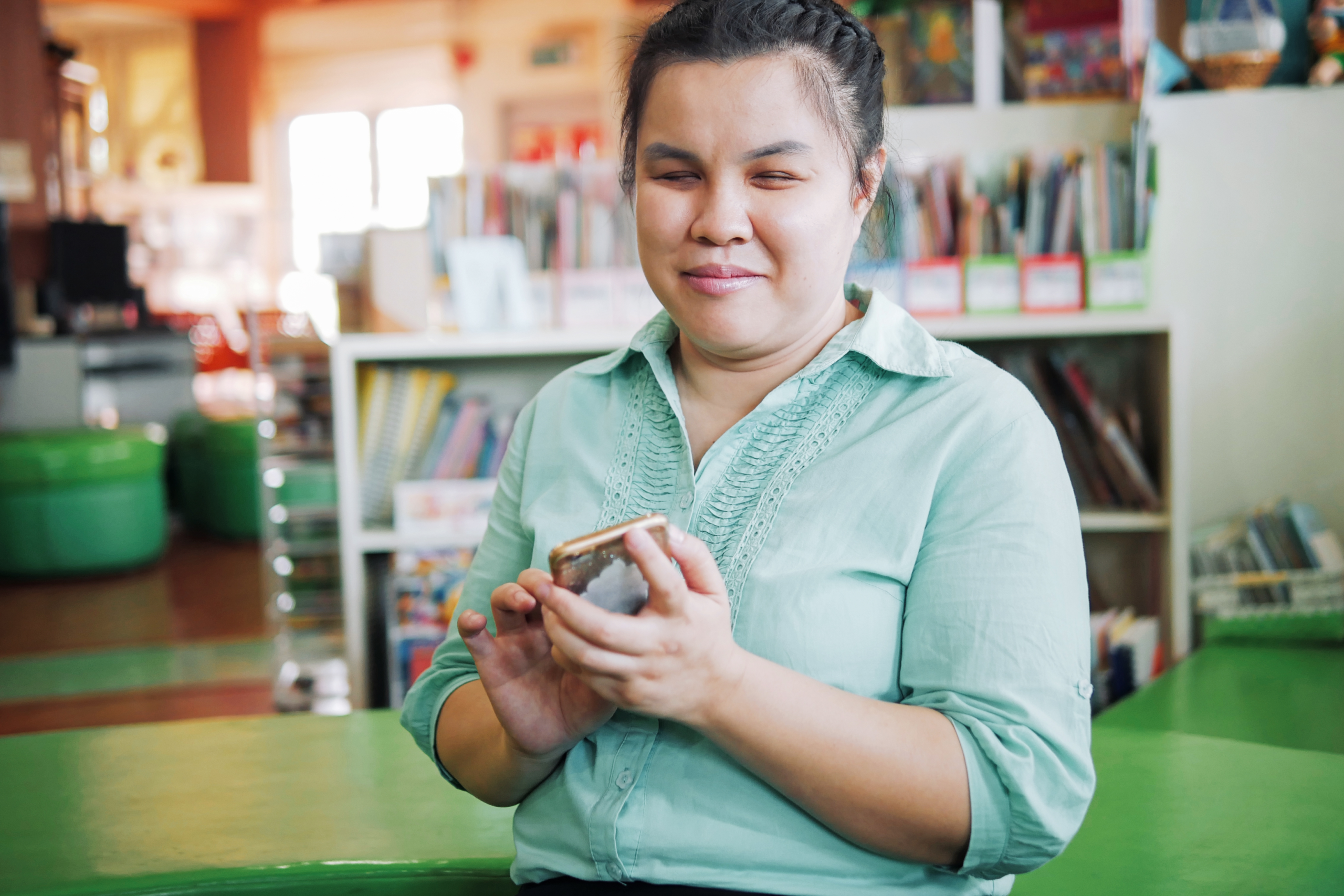 A blind woman testing accessibility on her phone.